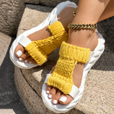 Braided open toe sandals with bright yellow knitted strap and thick white sole, ideal for summer fashion.
