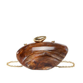 Oval shell acrylic evening bag in brown with gold clasp and chain strap.