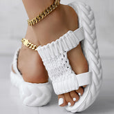 Platform sandals featuring a braided knit design, soft white color, and a thick sole for comfort. Braided knit summer sandals.