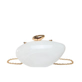 Oval shell acrylic evening bag in white with gold clasp and chain strap for evening events.