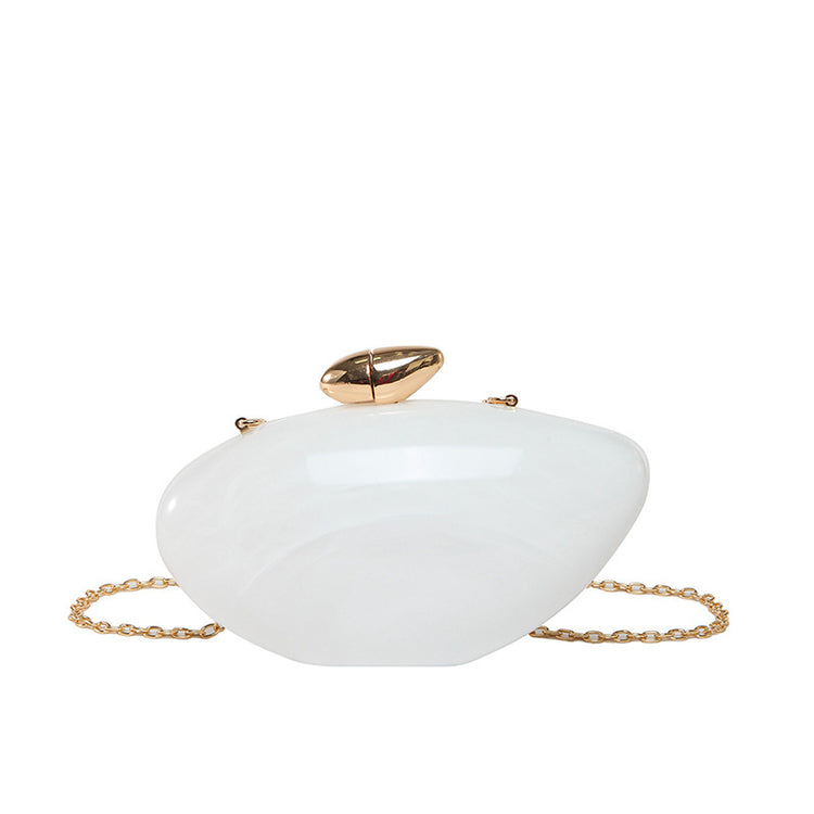 Oval shell acrylic evening bag in white with gold clasp and chain strap for evening events.