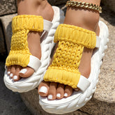 Braided open toe sandals with a bright yellow knitted strap and thick white sole, perfect for summer wear.