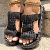 Braided knit platform sandals with black braided straps and thick sole, showcasing comfort and style.