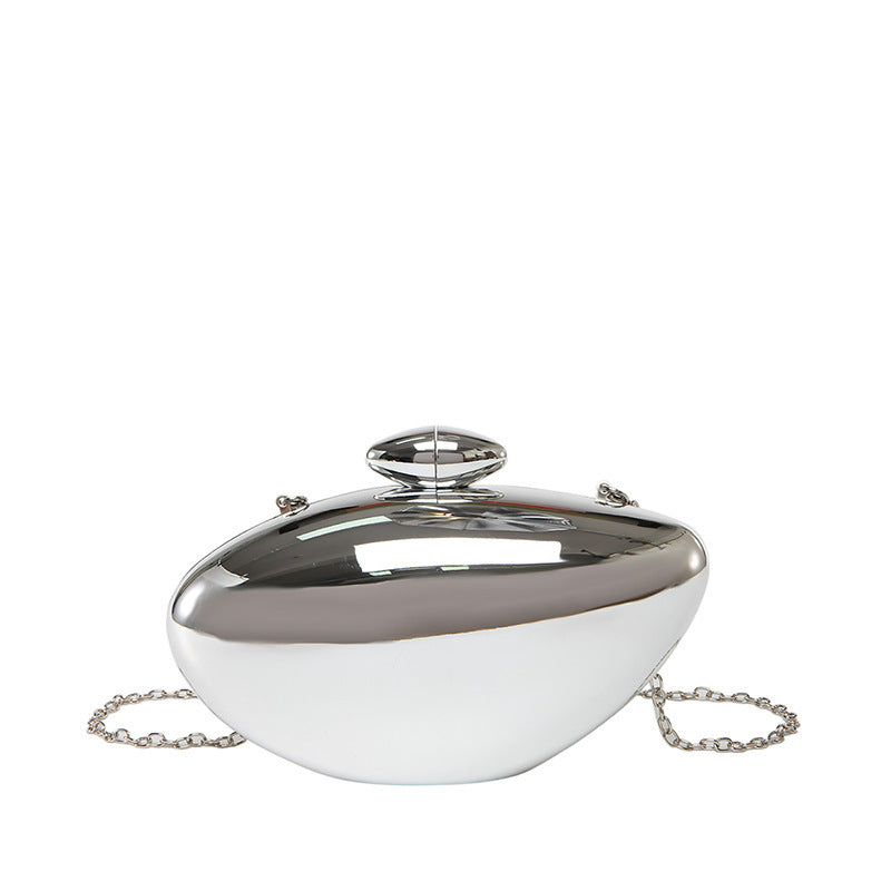 Oval shell acrylic evening bag in shiny silver color, featuring a unique oval shape and chain strap.