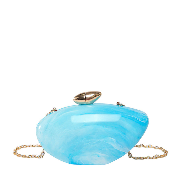 Oval shell acrylic evening bag in blue with gold clasp and chain strap, perfect for evening wear.
